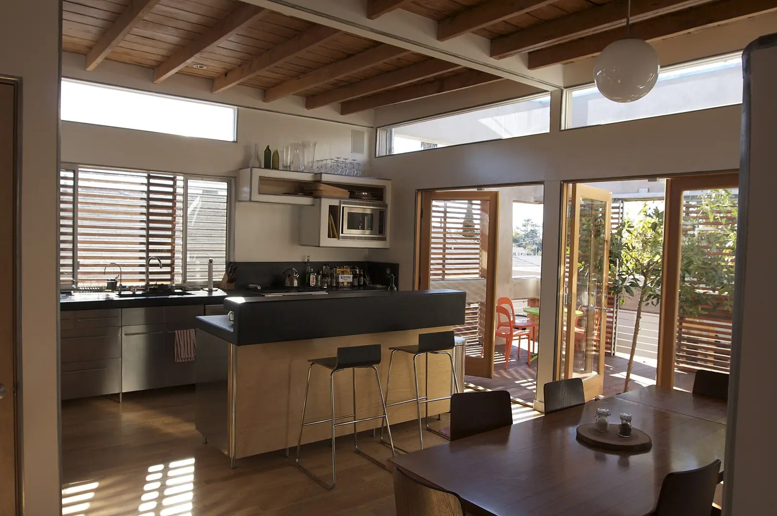 Remodeled kitchen with wood ceiling and bar stools