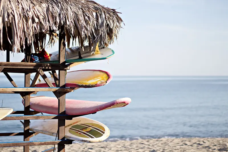 Surfboards on a rack by the beach